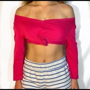 pink knotted long-sleeved crop top.